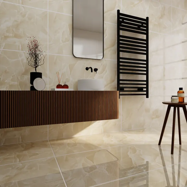 A long fluted walnut vanity set against cream onyx tile